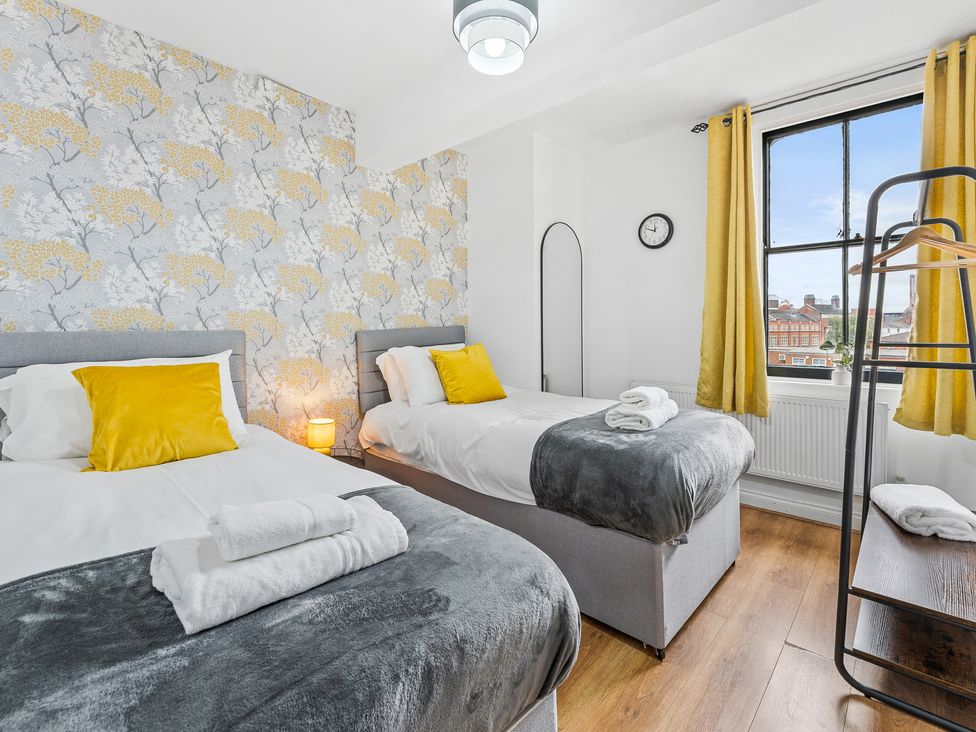 A bedroom with two beds and a window at The Craftsman Birmingham City Apartment Birmingham