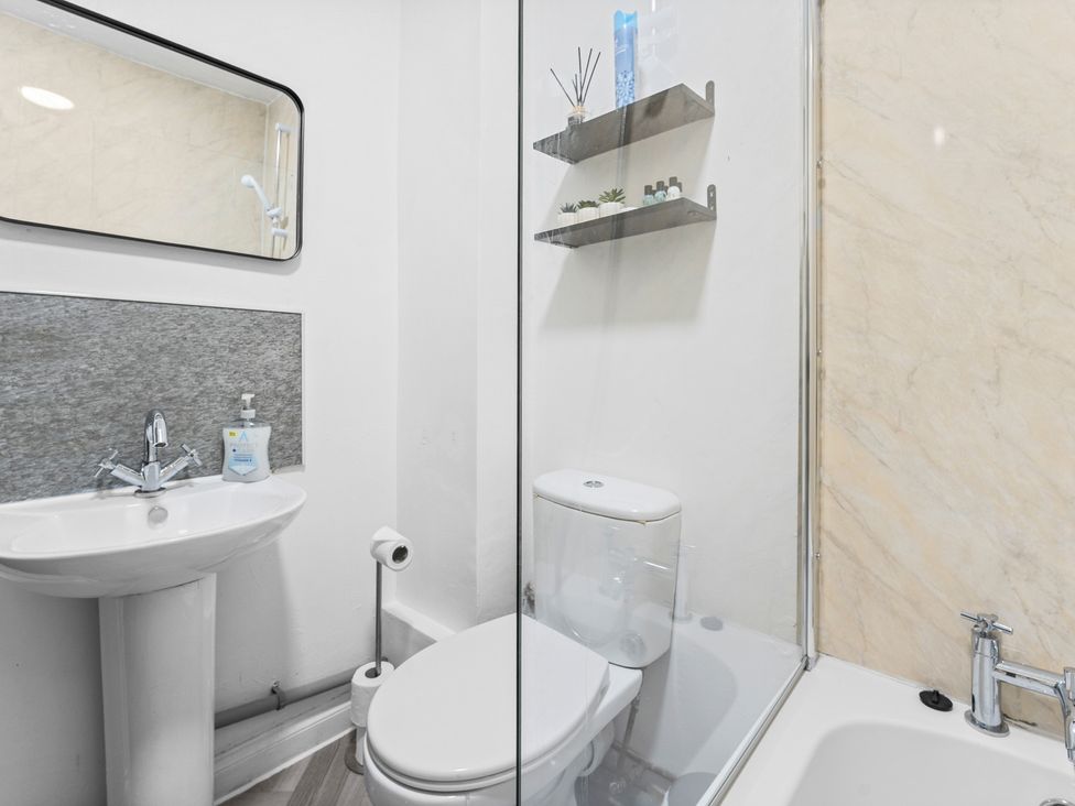 A bathroom with a sink and toilet at The Craftsman Birmingham City Apartment Birmingham