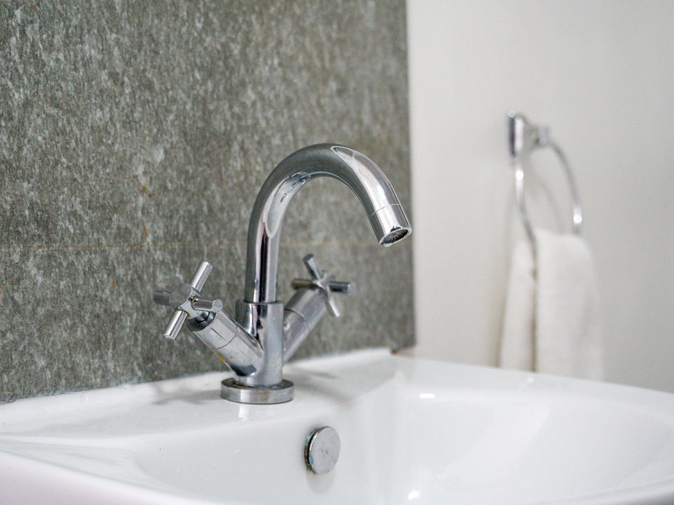 A faucet and sink in a bathroom at The Craftsman Birmingham City Apartment Birmingham