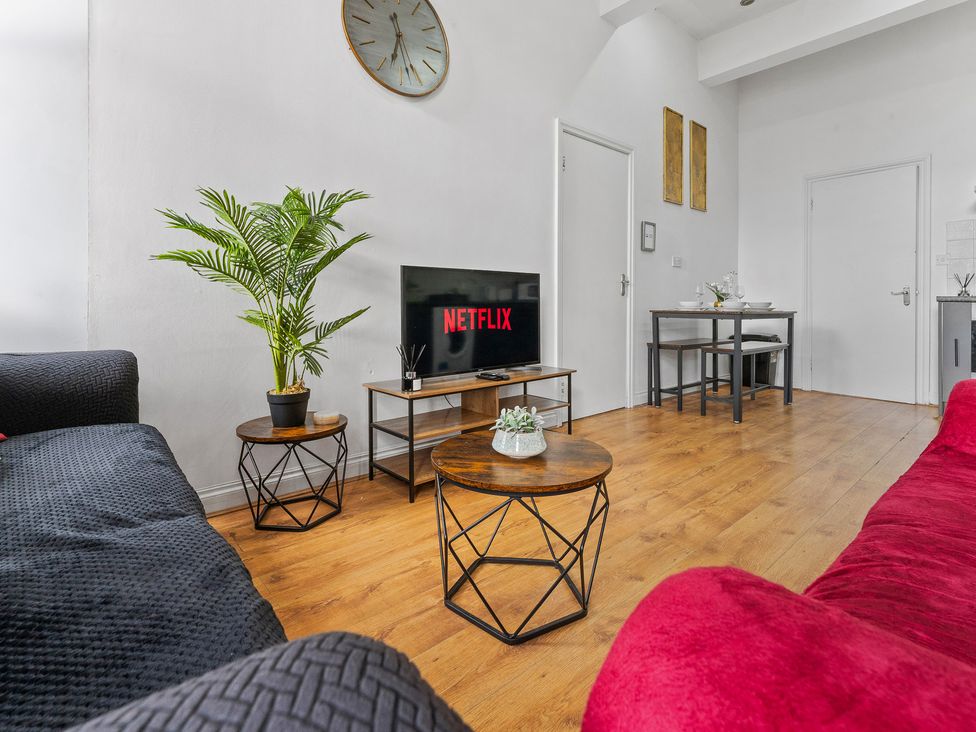 A living room with a television and a coffee table at The Goldsmith Birmingham City Apartment Birmingham