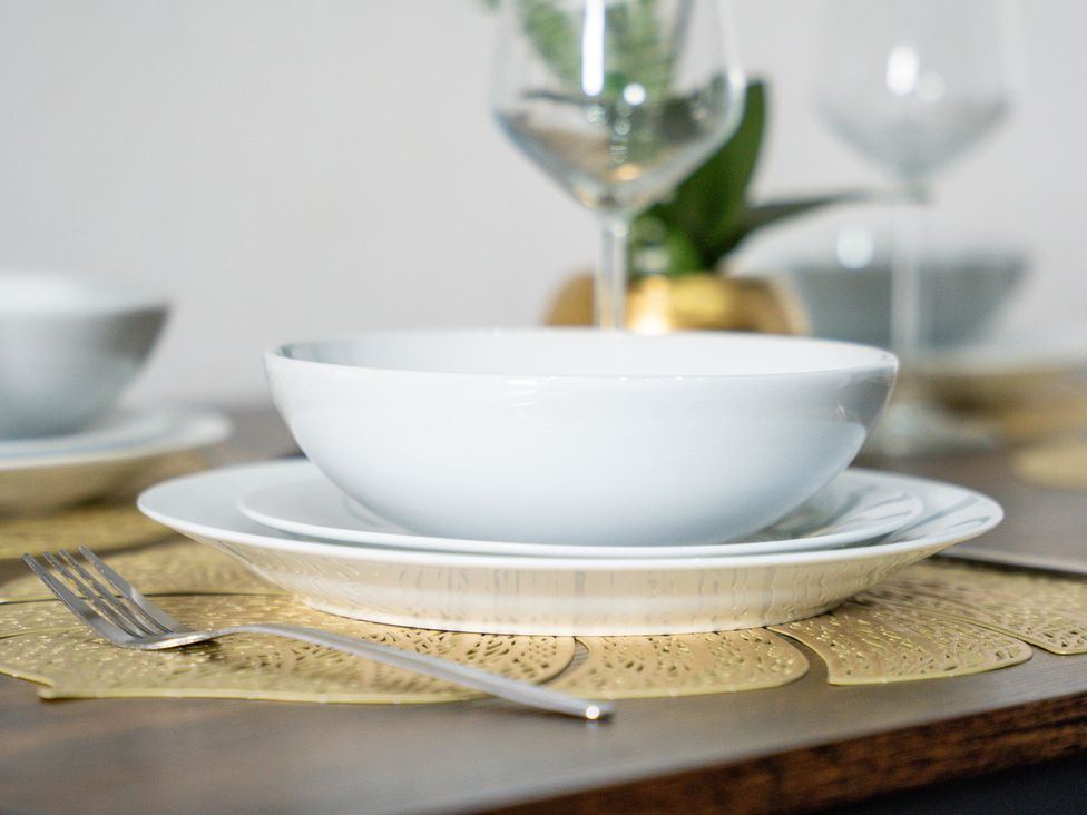 A bowl and plate on a table mat at The Goldsmith Birmingham City Apartment Birmingham