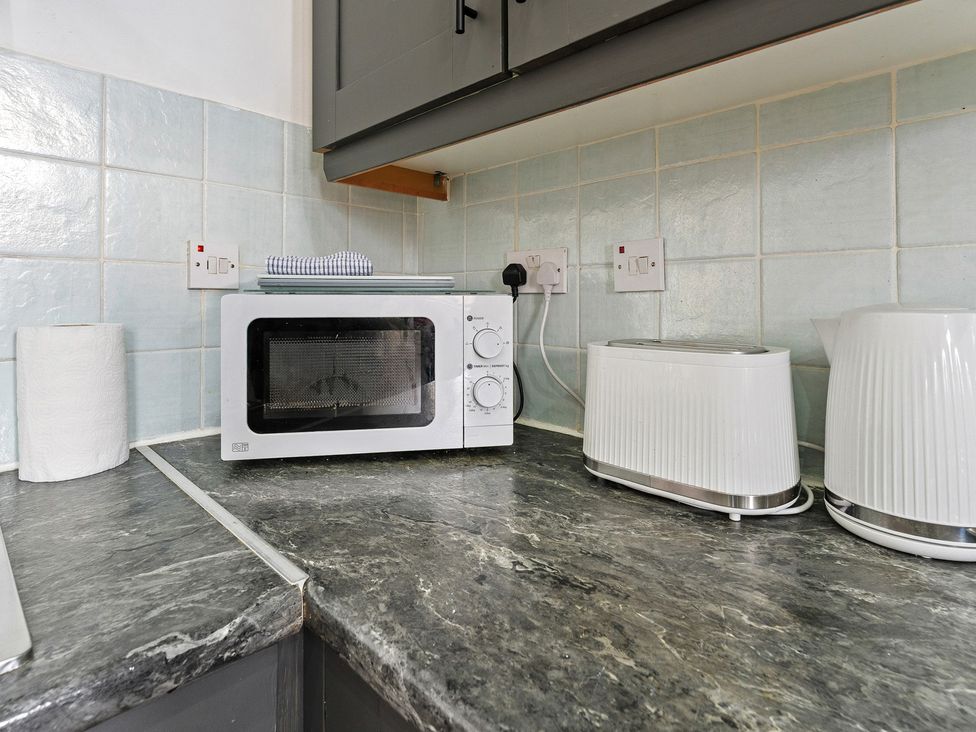 A kitchen with a microwave and toaster at The Goldsmith Birmingham City Apartment Birmingham
