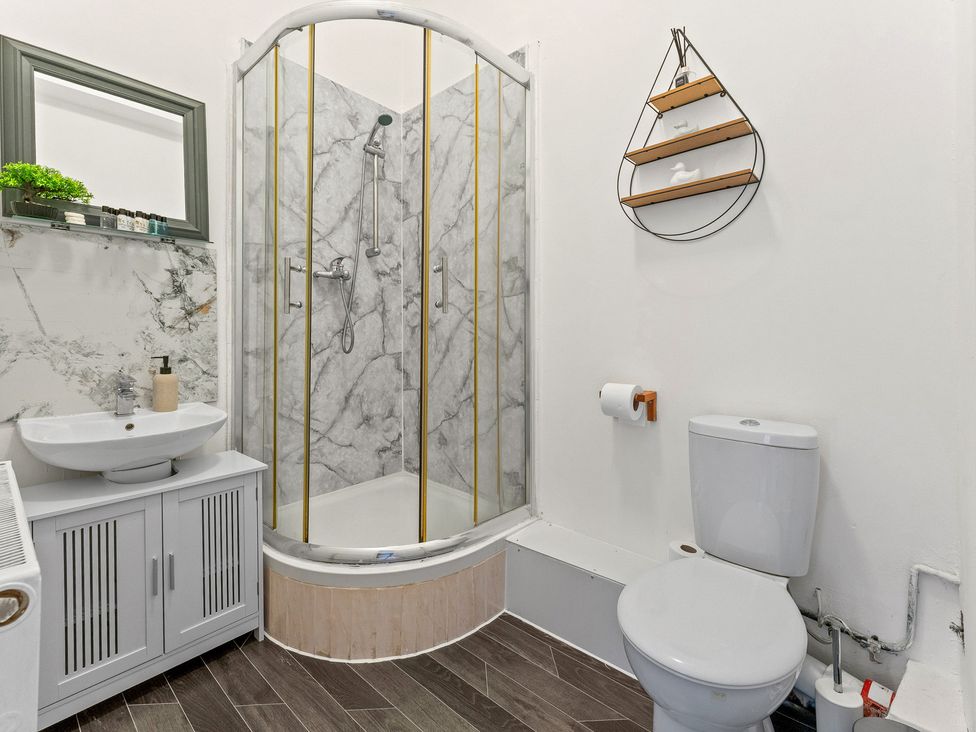 A bathroom with a shower, sink, and toilet at The Goldsmith Birmingham City Apartment Birmingham
