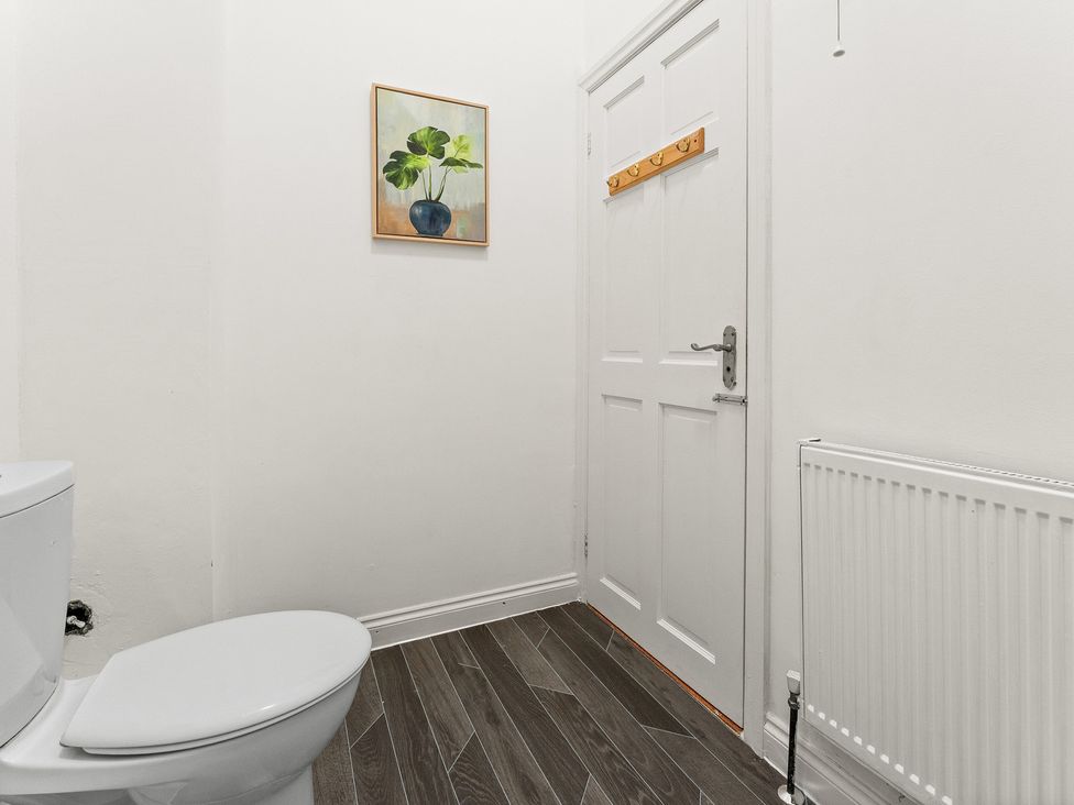A bathroom with a toilet and a door at The Goldsmith Birmingham City Apartment Birmingham