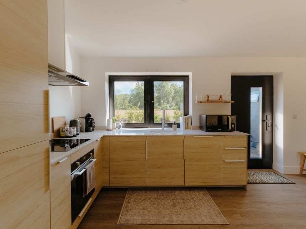 A kitchen with cabinets and appliances at Baldslow Stables in Battle near Hastings