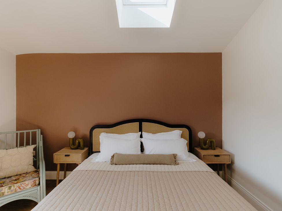 A bedroom with a large bed and a child's bed at Baldslow Stables in Battle near Hastings