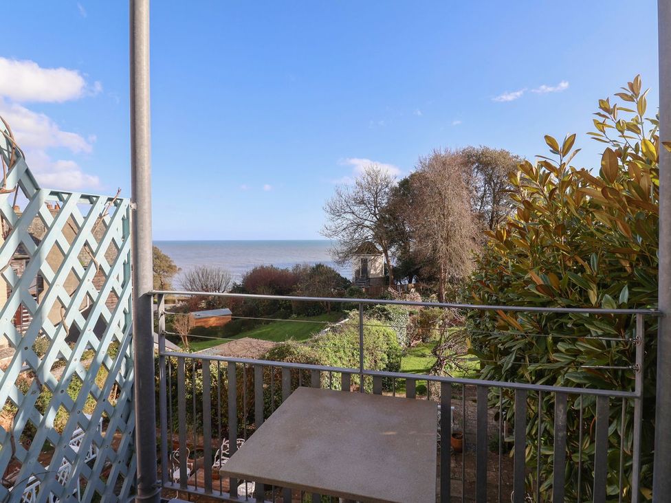 A view of the sea and garden from a balcony at 2 St. Michaels House in Lyme Regis