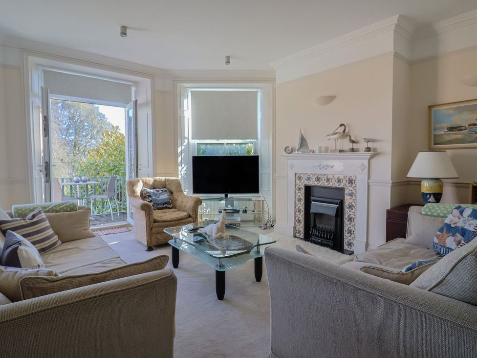 A living room with a television and fireplace at 2 St. Michaels House in Lyme Regis