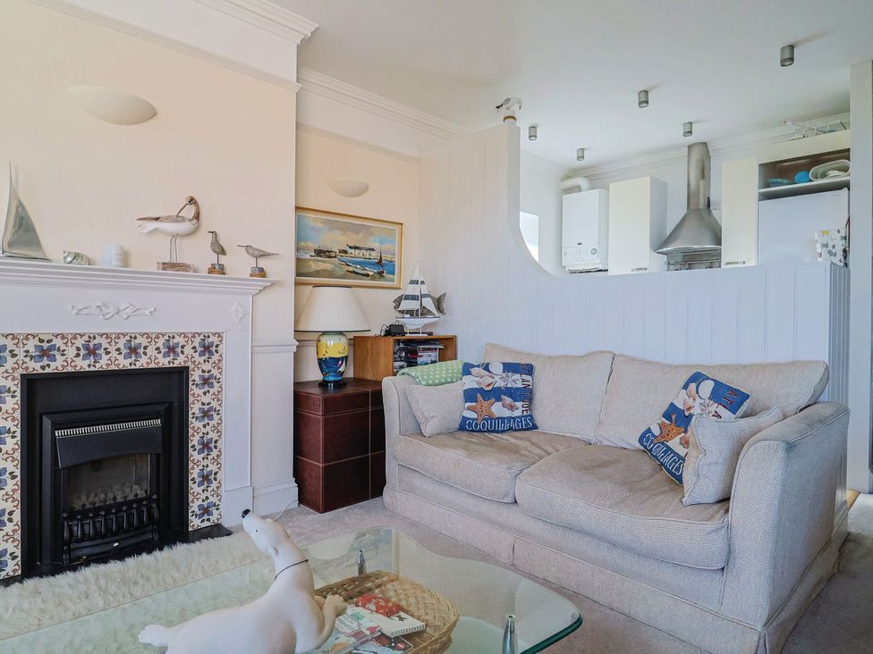 A living room with a sofa and fireplace at 2 St. Michaels House in Lyme Regis