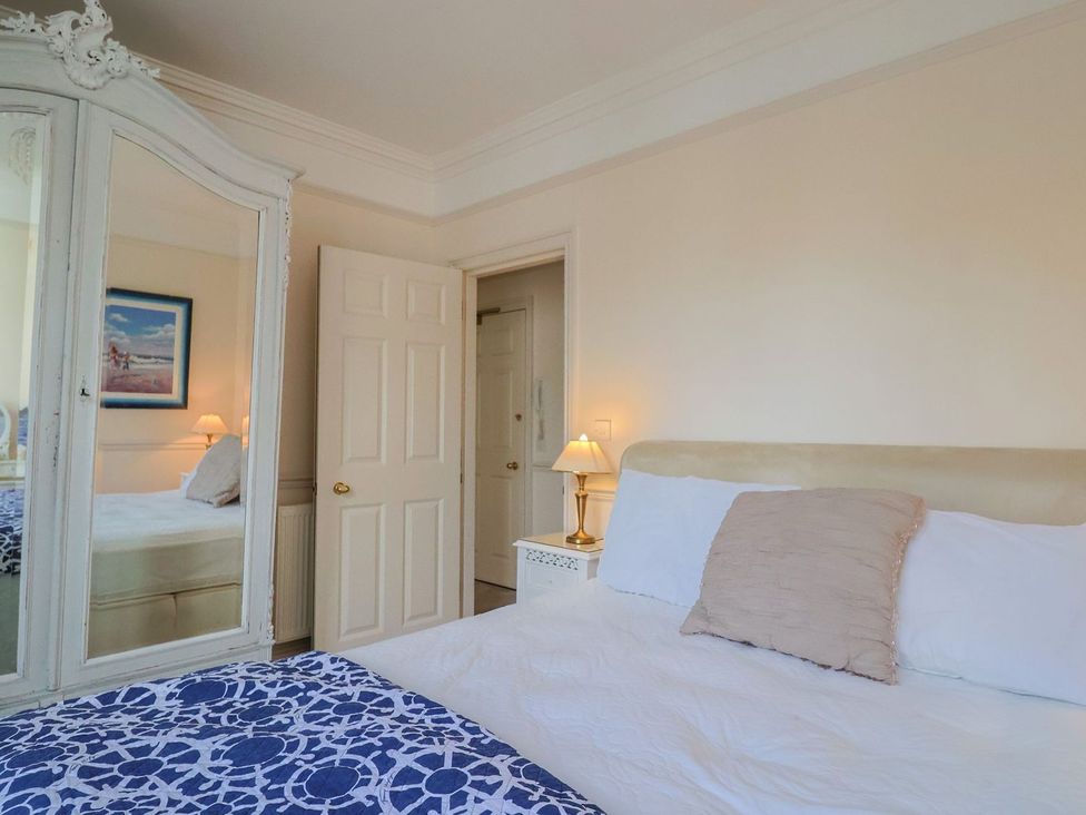A bedroom with a bed and a lamp at 2 St. Michaels House Lyme Regis