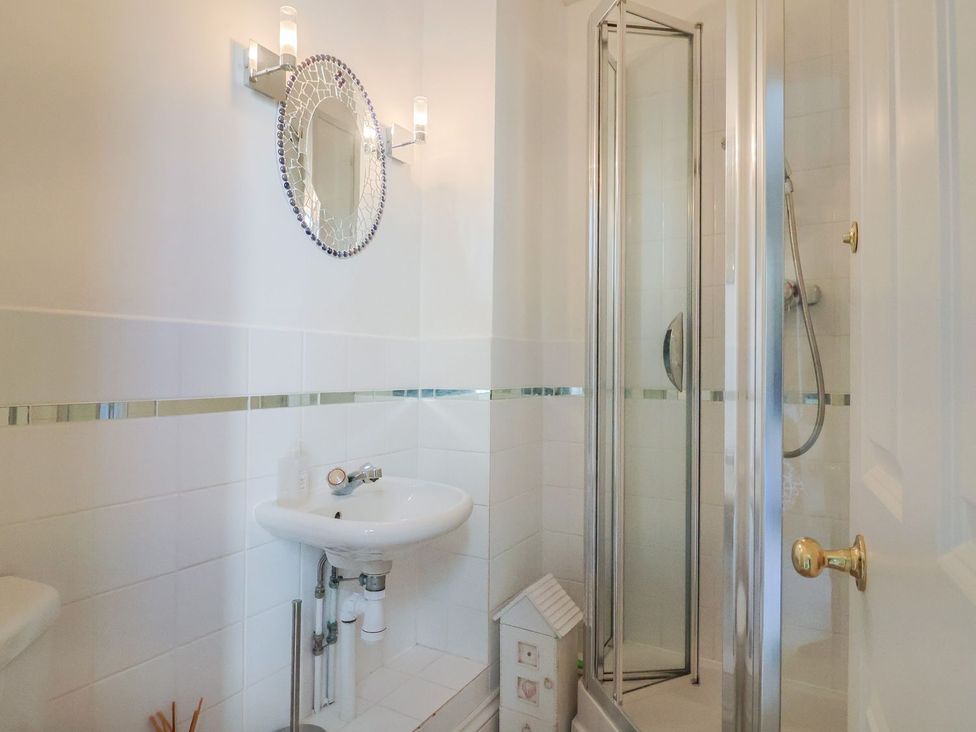 A bathroom with a sink and shower at 2 St. Michaels House in Lyme Regis