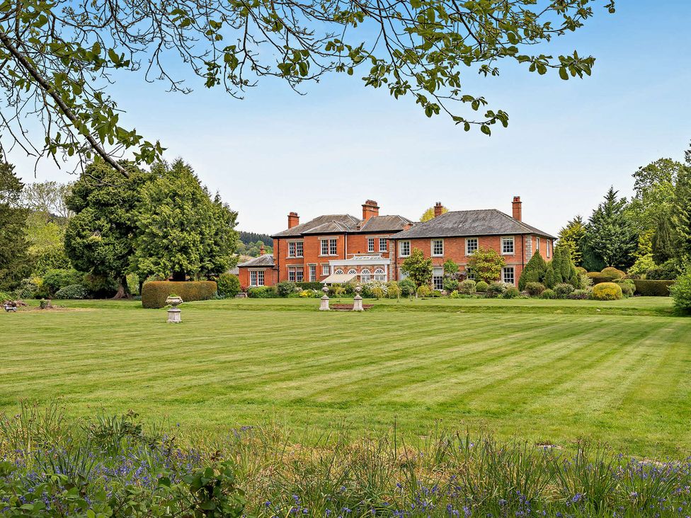 A house with a lawn and trees at Staunton Park in Leominster