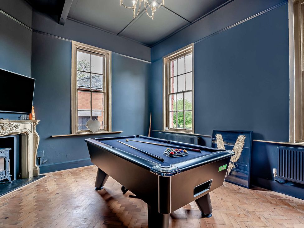 A game room with a pool table and television at Staunton Park in Leominster