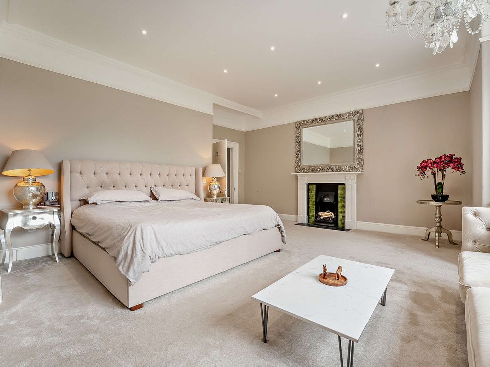 A bedroom with a bed and fireplace at Staunton Park in Leominster