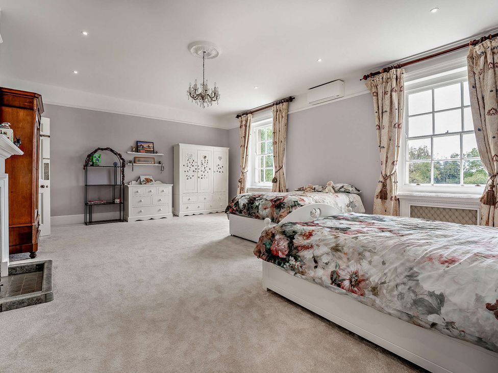 A bedroom with two beds and furniture at Staunton Park Leominster