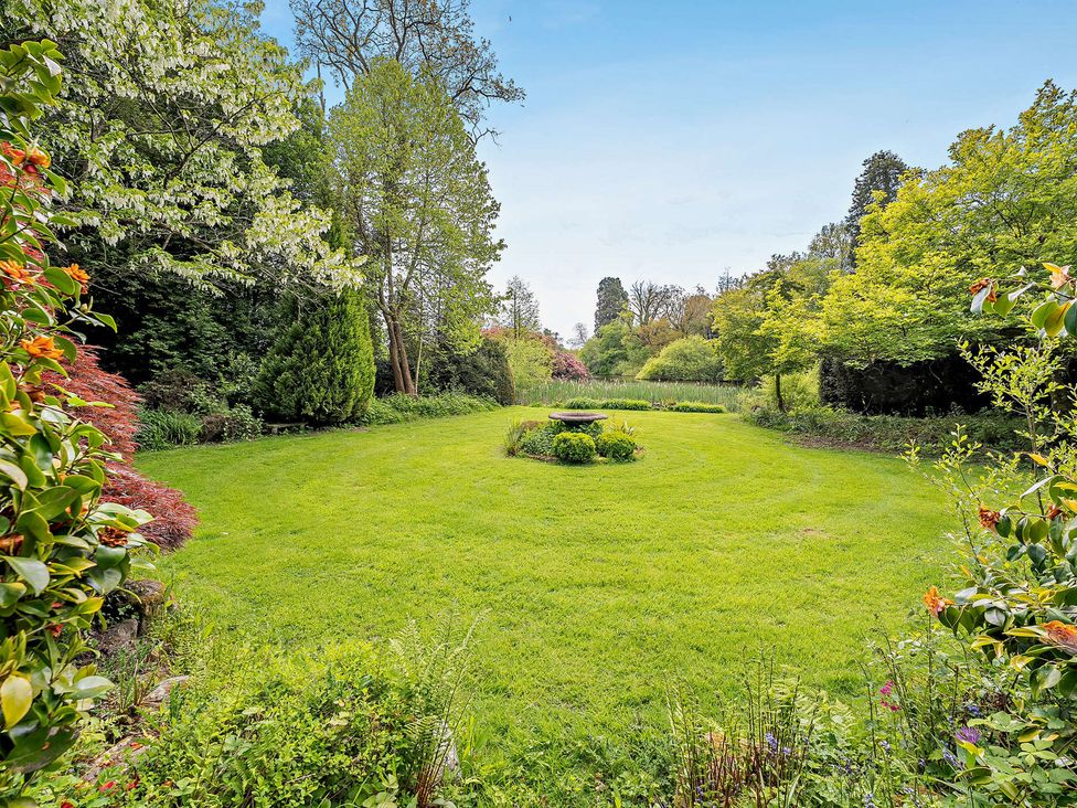 A garden with grass and trees at Staunton Park in Leominster