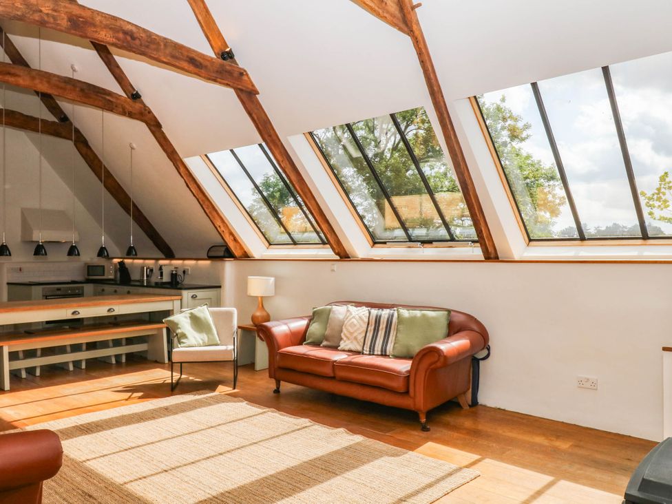 A living room with a sofa and coffee table at The Hayloft at Manaton