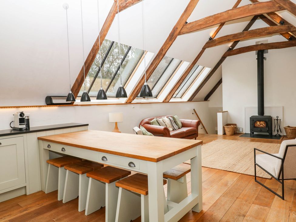 A living room with a kitchen island and sofa at The Hayloft at Manaton