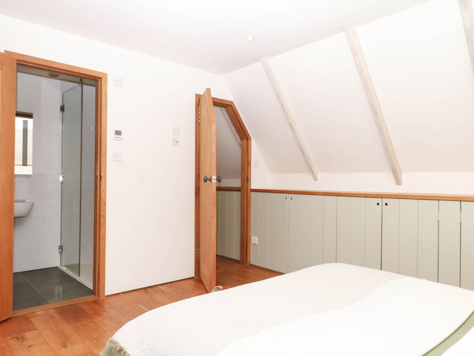 A bedroom with a shower and toilet at The Hayloft at Manaton