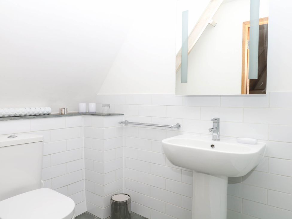 A bathroom with a sink and toilet at The Hayloft at Manaton