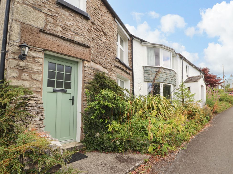 A house with a green door and windows at The Orchard in Levens