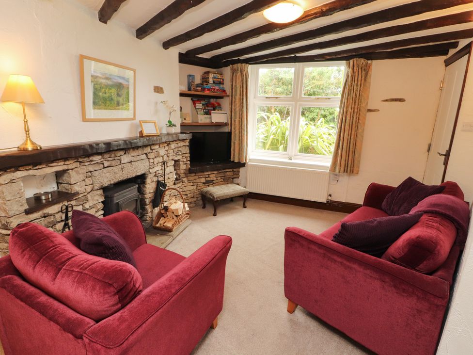 A living room with sofas and a fireplace at The Orchard in Levens