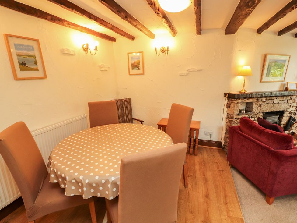 A dining room with a round table and chairs at The Orchard in Levens