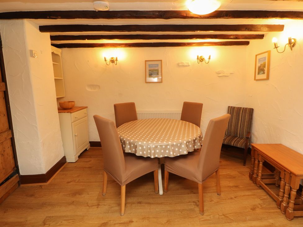 A dining room with a round table and chairs at The Orchard in Levens