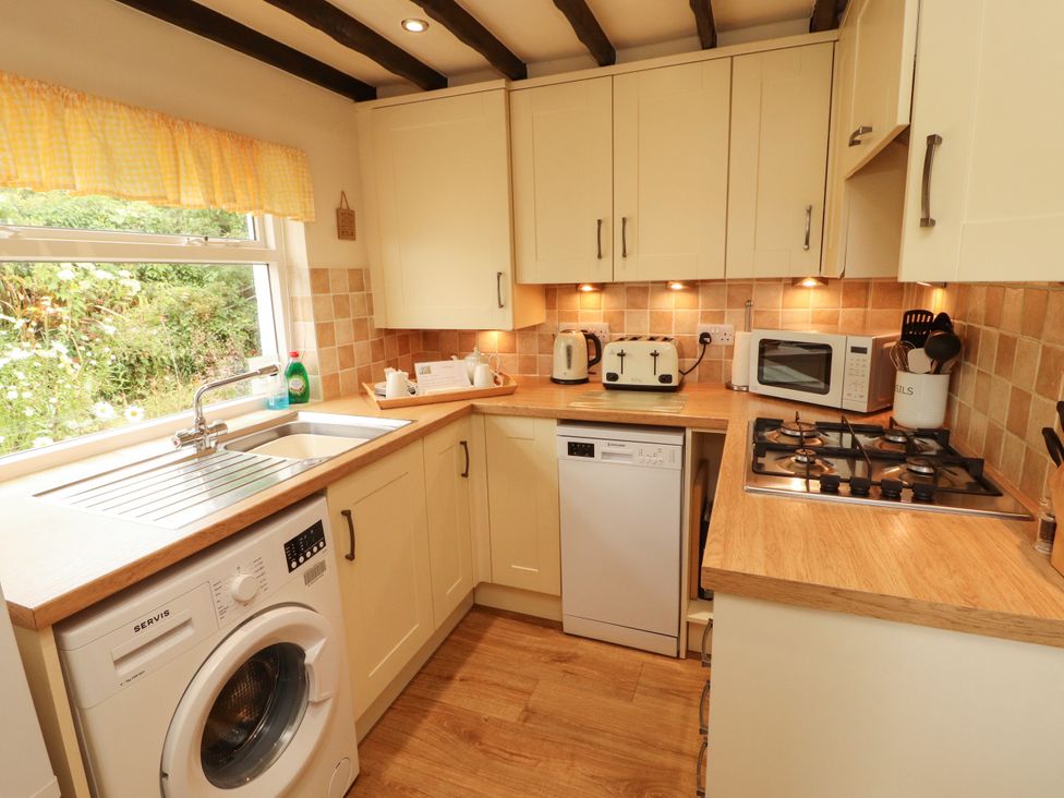 A kitchen with appliances and a window at The Orchard in Levens