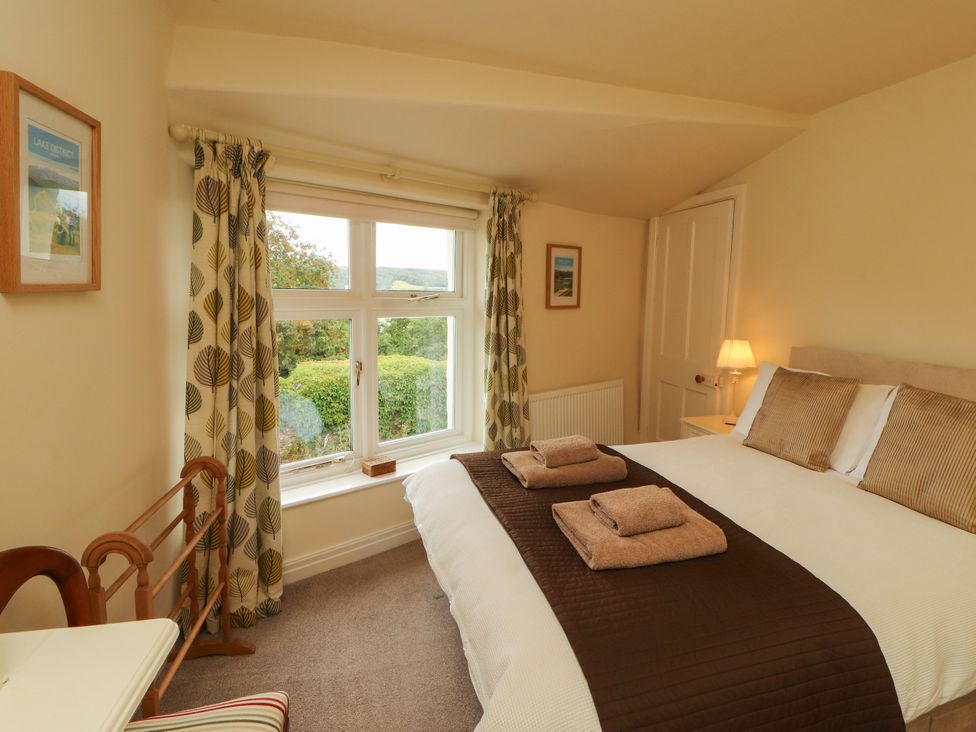 A bedroom with a bed and window at The Orchard in Levens