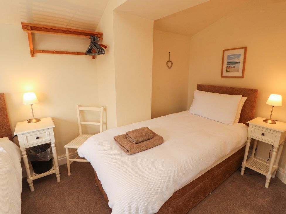 A bedroom with two single beds and nightstands at The Orchard in Levens