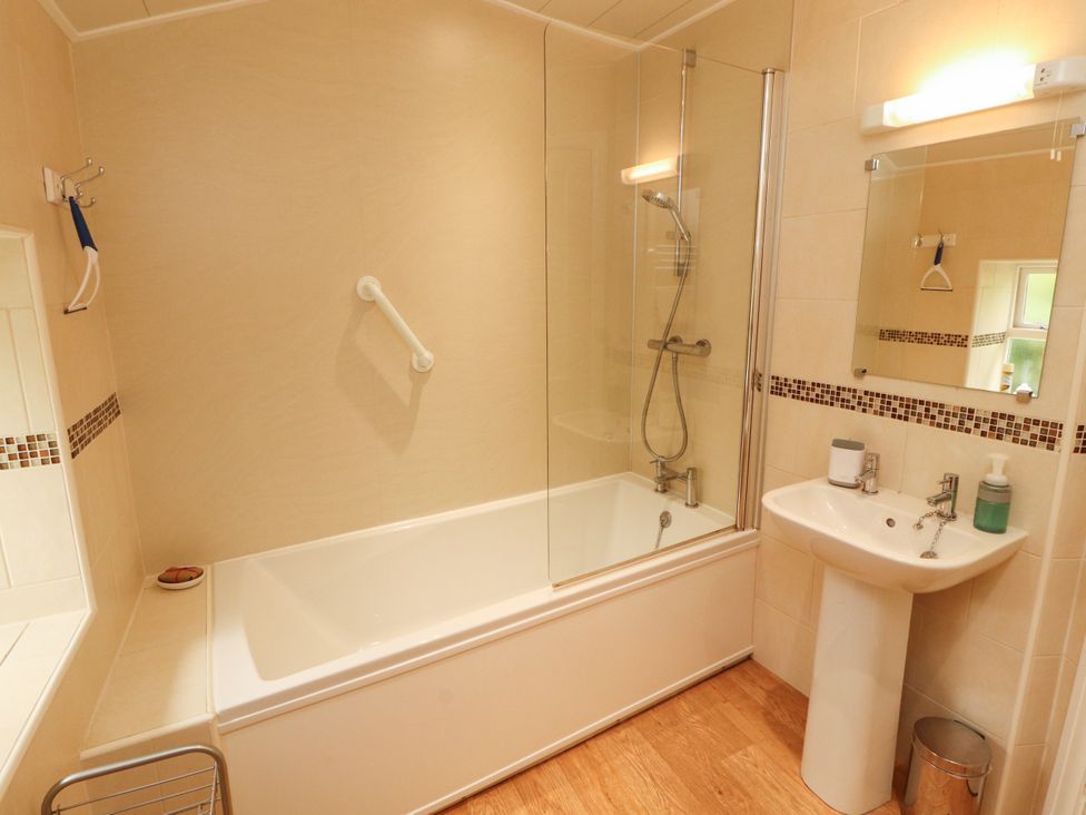 A bathroom with a bathtub and sink at The Orchard in Levens