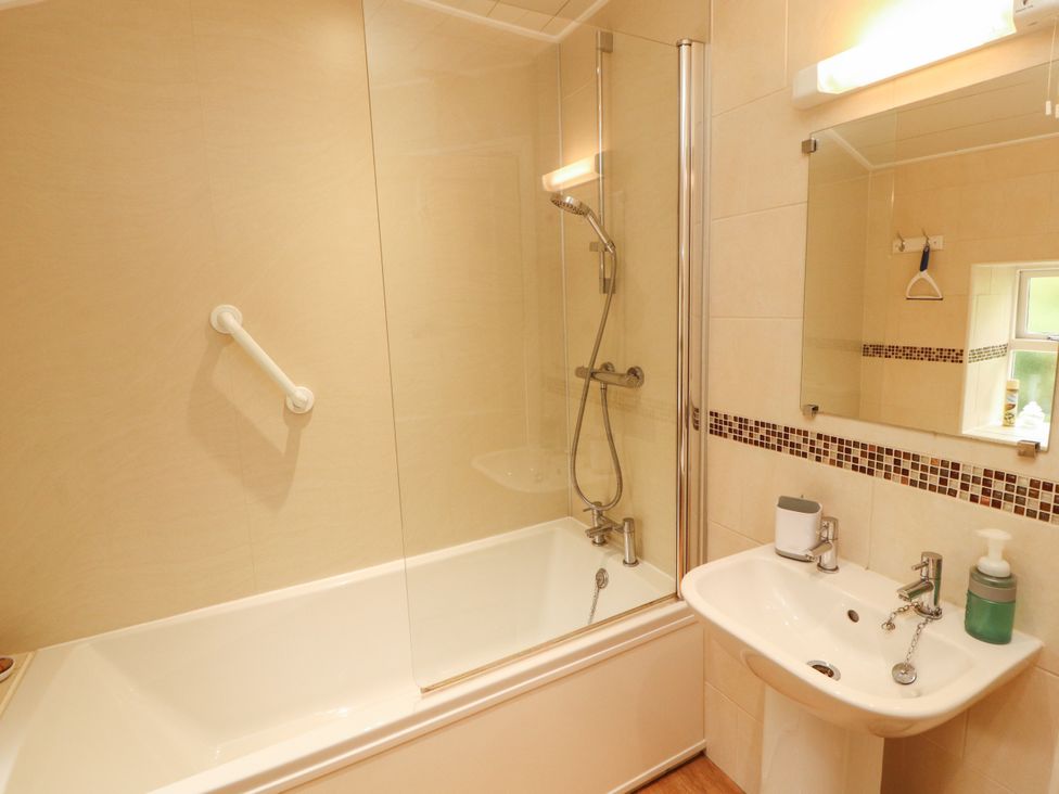 A bathroom with a bathtub and sink at The Orchard in Levens