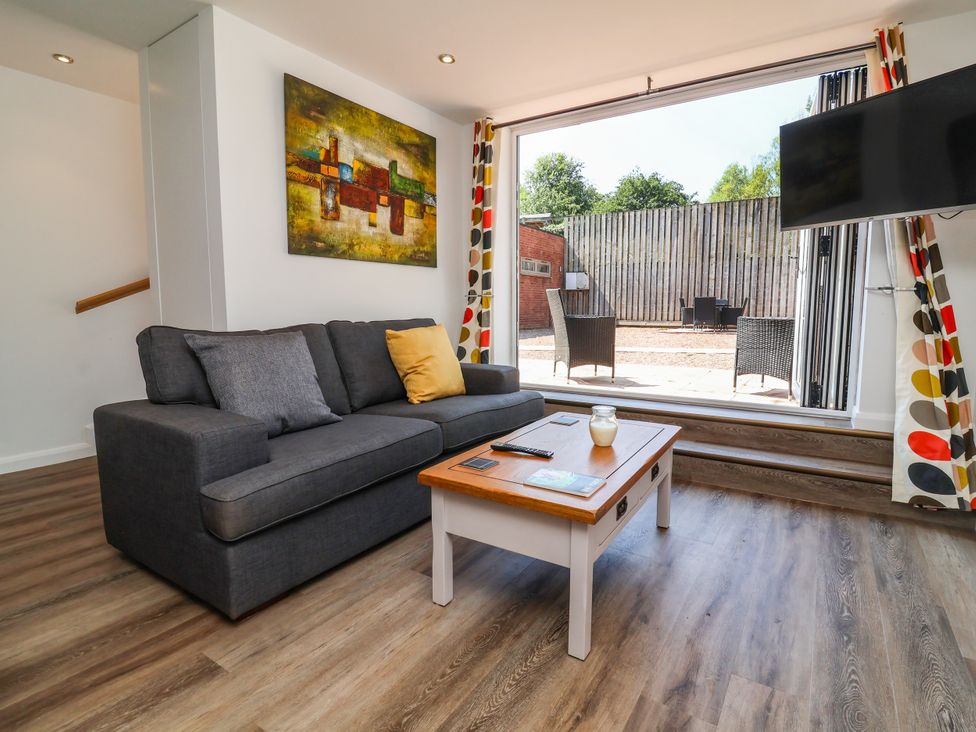 A living room with a sofa and coffee table at Down Cottage in Zeal Monachorum