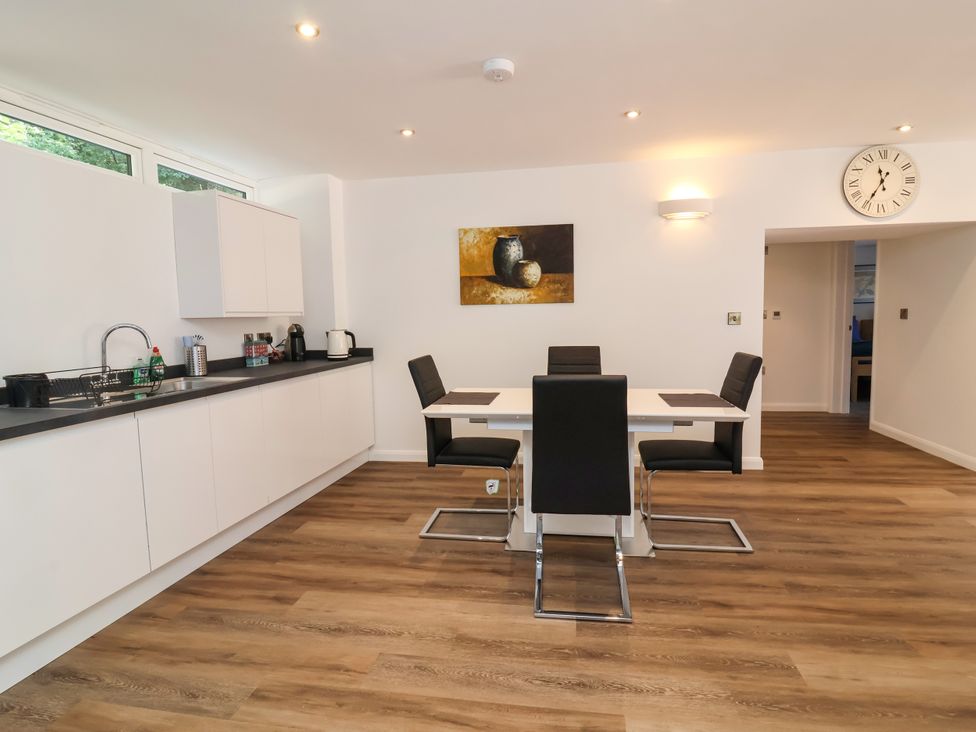 A kitchen with a dining table and chairs at Down Cottage in Zeal Monachorum