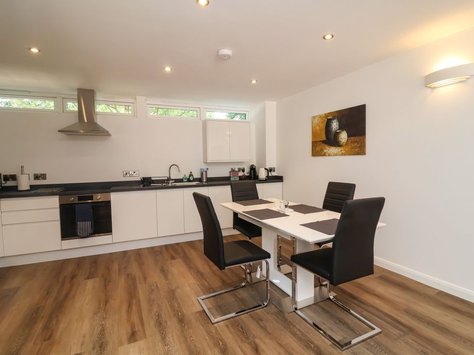 A kitchen with a dining table and chairs at Down Cottage in Zeal Monachorum