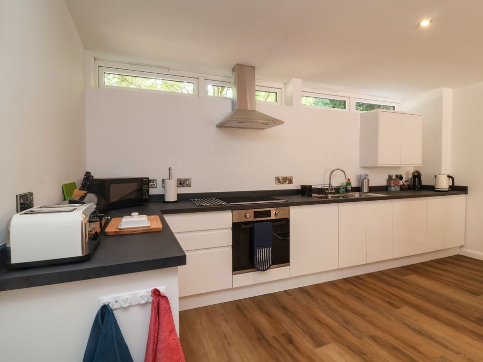 A kitchen with appliances and a countertop at Down Cottage Zeal Monachorum