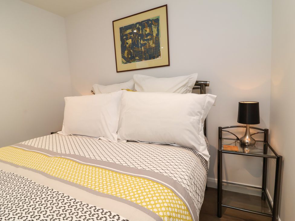 A bedroom with bed and nightstand at Down Cottage in Zeal Monachorum