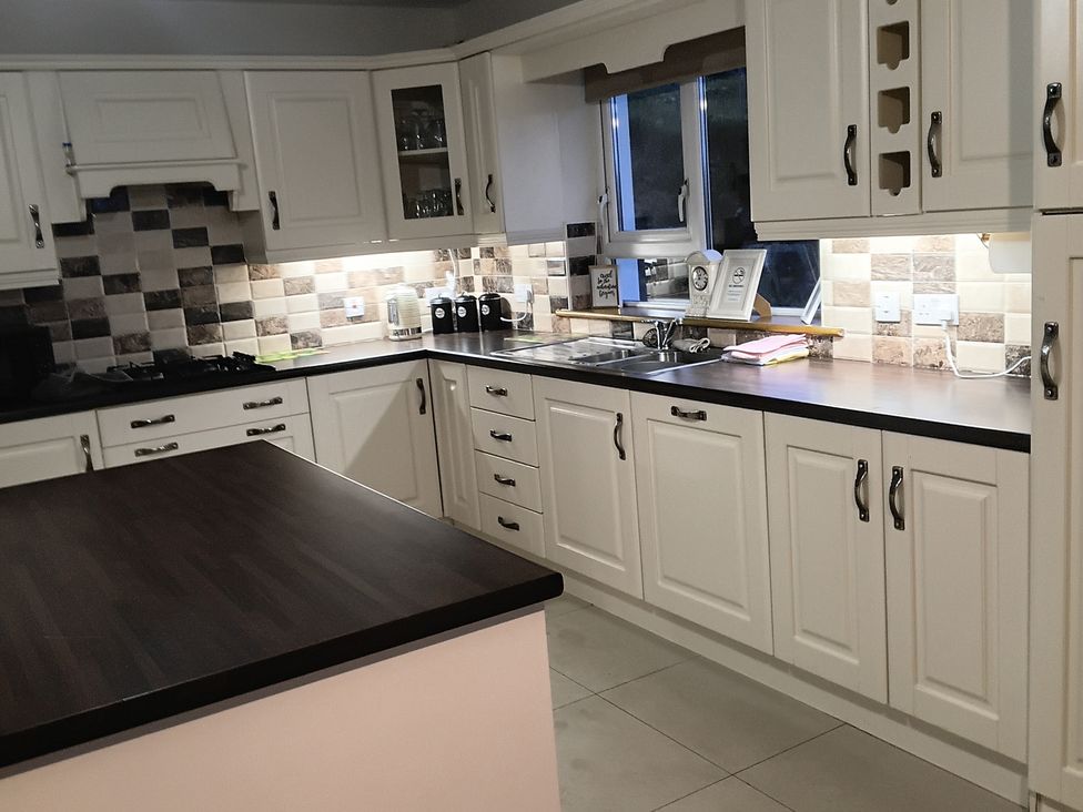 A kitchen with cabinets and countertop at Sliabh League Mountain Lodge TEILEANN near Kilcar, County Donegal