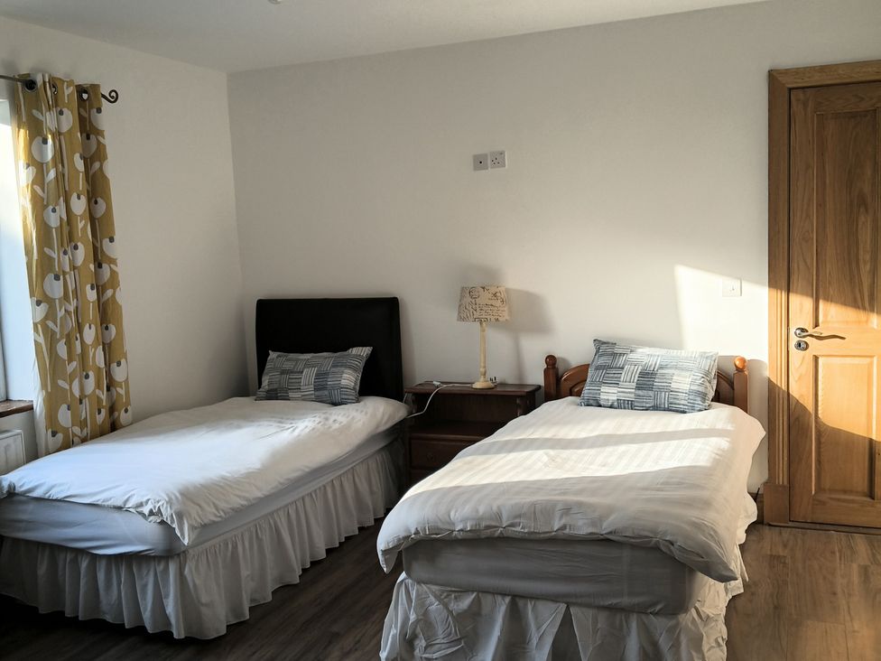 A bedroom with two beds and a lamp at Sliabh League Mountain Lodge TEILEANN near Kilcar, County Donegal