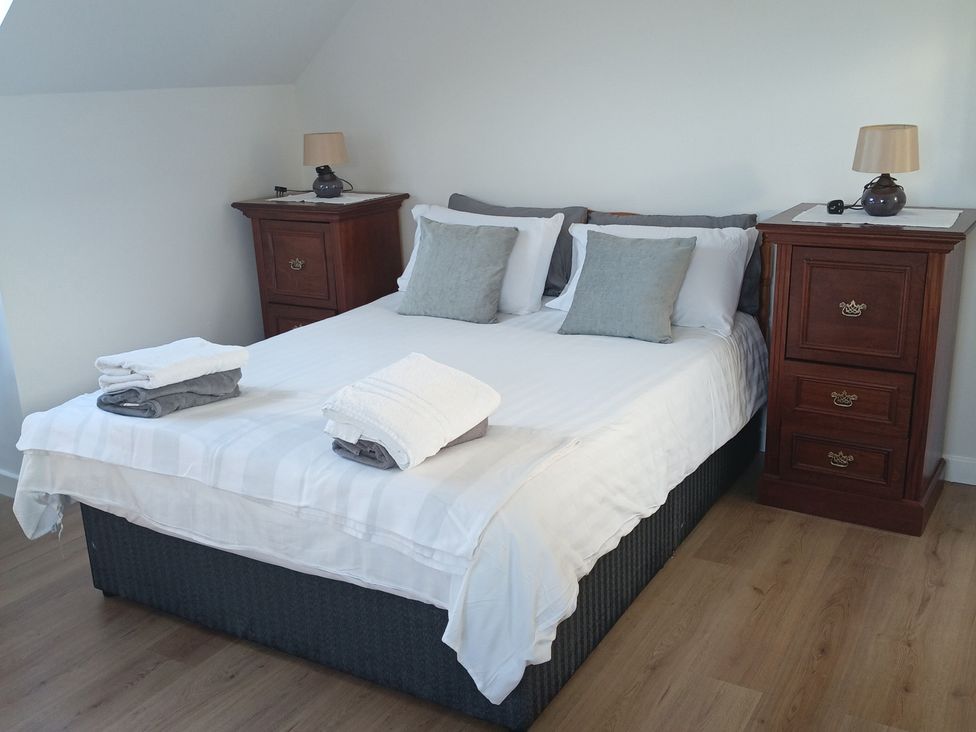 A bedroom with a bed and bedside tables at Sliabh League Mountain Lodge TEILEANN near Kilcar, County Donegal