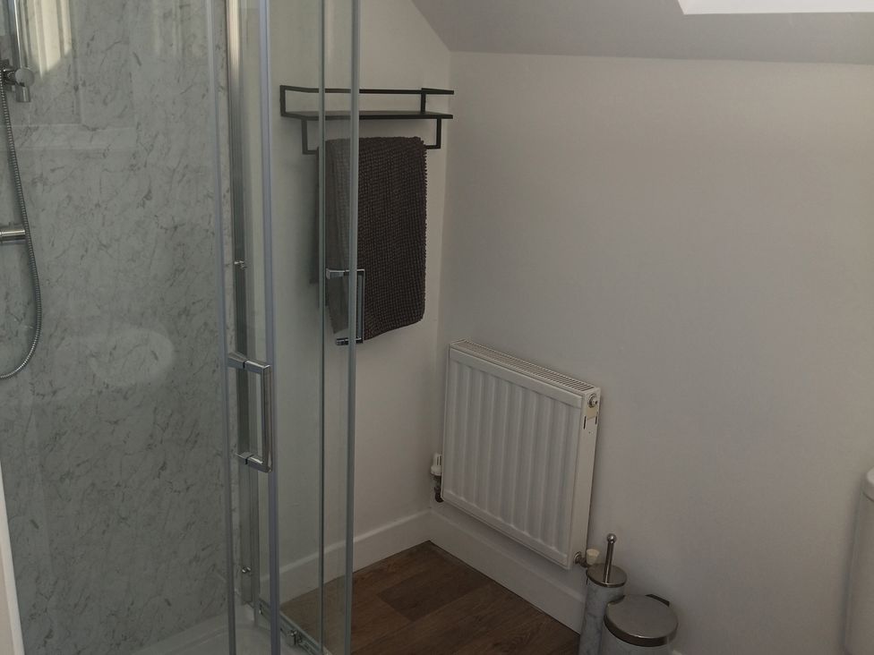 A bathroom with a shower and towel rack at Sliabh League Mountain Lodge TEILEANN near Kilcar, County Donegal