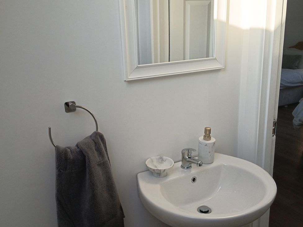 A bathroom with a sink and mirror at Sliabh League Mountain Lodge TEILEANN near Kilcar, County Donegal