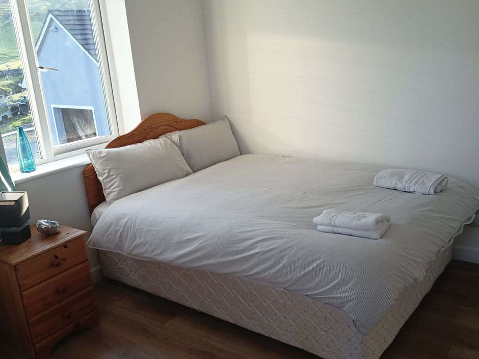 A bedroom with a bed and a nightstand at Sliabh League Mountain Lodge TEILEANN near Kilcar, County Donegal