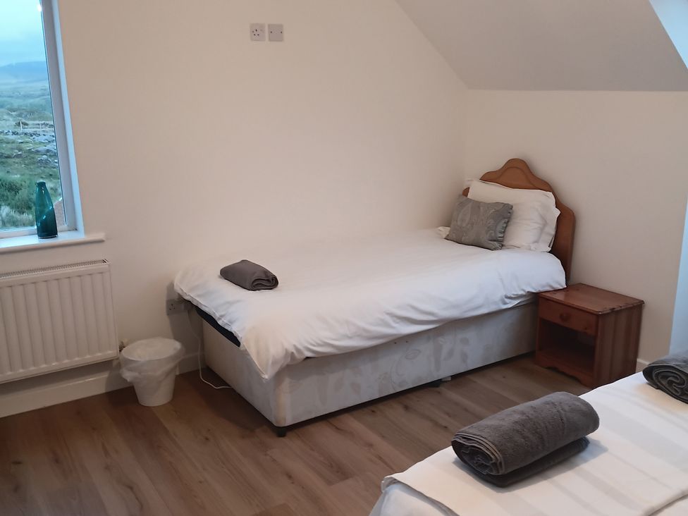 A bedroom with a single bed and nightstand at Sliabh League Mountain Lodge TEILEANN near Kilcar, County Donegal