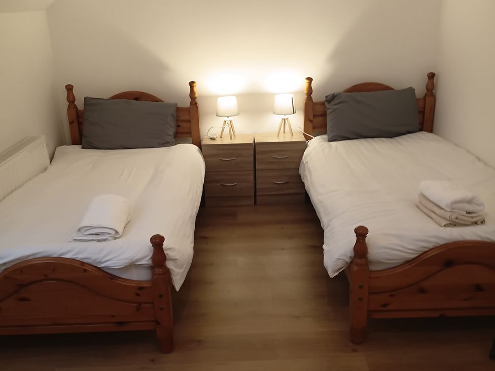 A bedroom with two beds and nightstands at Sliabh League Mountain Lodge TEILEANN near Kilcar, County Donegal