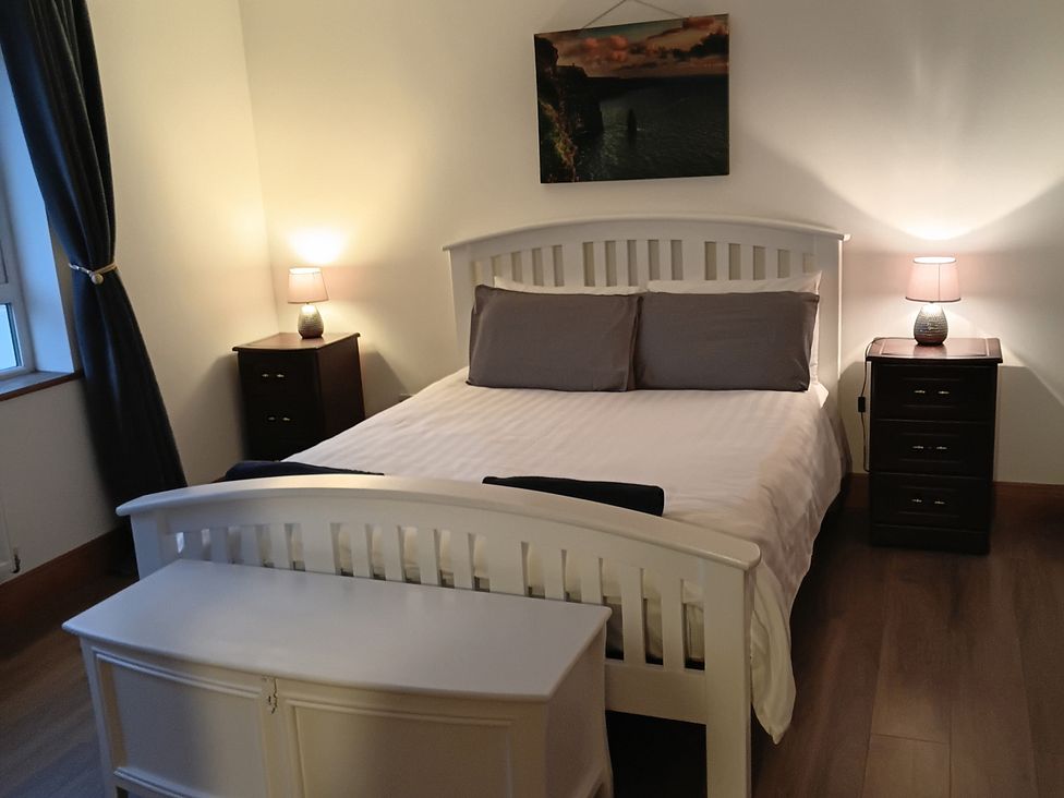 A bedroom with a bed and nightstands at Sliabh League Mountain Lodge in TEILEANN near Kilcar, County Donegal