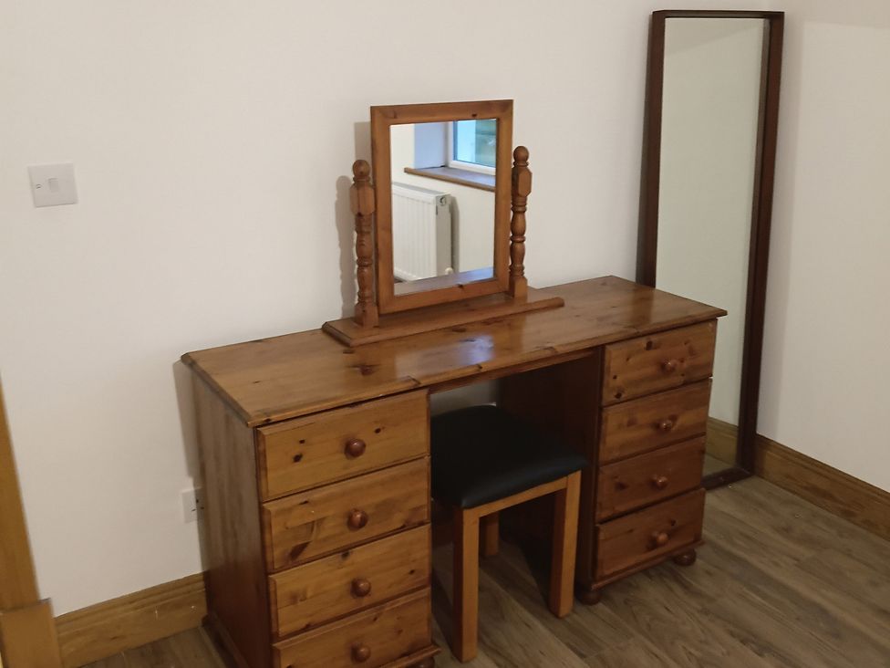 A vanity table with a mirror in a bedroom at Sliabh League Mountain Lodge TEILEANN near Kilcar, County Donegal