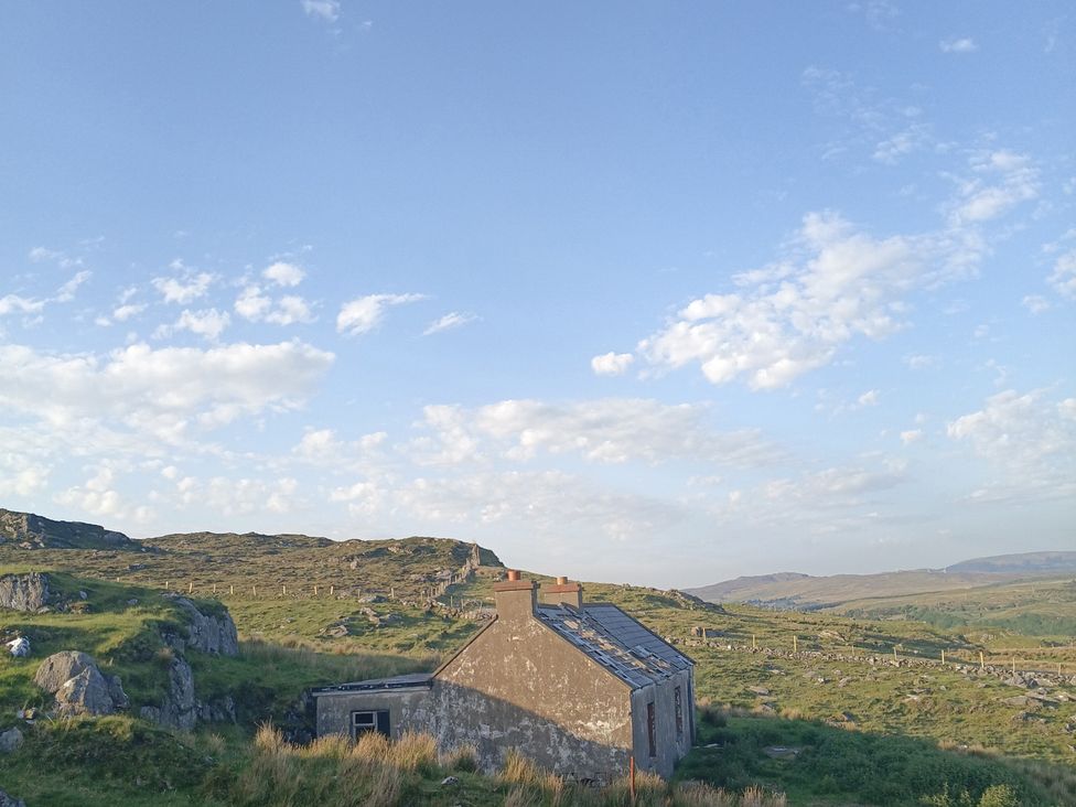 An abandoned building on a hillside with clouds in the sky at Sliabh League Mountain Lodge TEILEANN near Kilcar, County Donegal