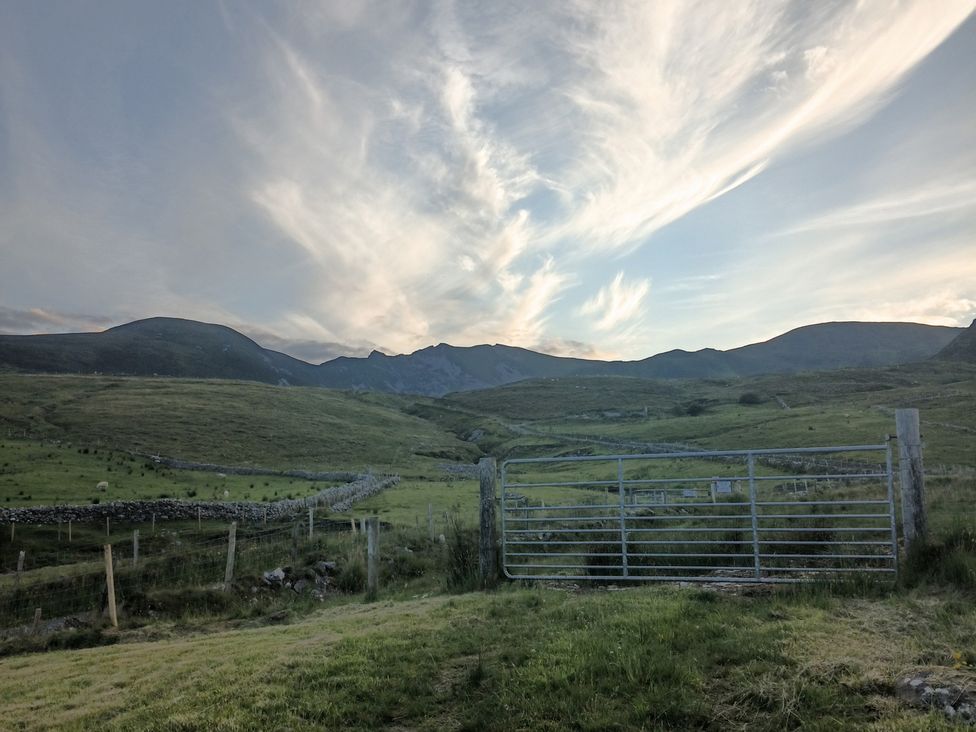 A gate in front of mountains and grass at Sliabh League Mountain Lodge in TEILEANN near Kilcar, County Donegal